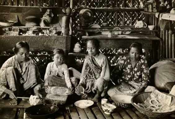 A group of Indonesian women prepare traditional food in the kitchen. Sourced from Collection Tropenmuseum.